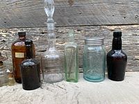 Front view of primary larger bottles including decanter, apothecary, beer, medicine and fruit jar