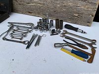 Spread of all tools laid out showing socket assortment, wrenches, pliers, screwdrivers, Allen keys, hammer, awl