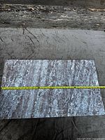 Top view of full marble slab with measuring tape showing length