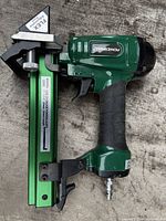 Left side view of Powernail 2000F Flex pneumatic cleat nailer showing model and gauge markings