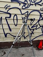 Full view of silver aluminum Vivitar tripod fully extended