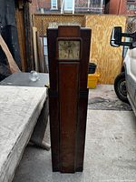 Full frontal view of tall wooden Westinghouse floor radio clock