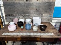 All thirteen planters displayed on table