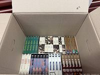 Top layer of boxed VHS tapes showing assorted sets and titles