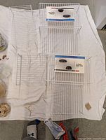Six Grayline wire shelves laid out, visible dimensions relative; packaging cards on some shelves