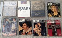 All eight hardcover art books laid out front covers visible