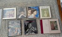 Eight oversized hardcover books laid out showing front covers