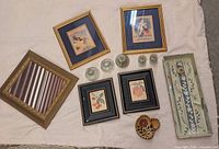 Group shot showing seven framed prints of varied subjects and frame styles on cloth background