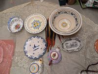 Overhead view of entire lot showing plates, nested bowls, chopsticks, trinket pieces, necklace