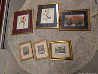 Group shot of all five framed prints on lace cloth