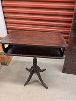 Entire table showing top, shelf, pedestal base