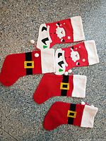 Five stockings laid out showing two styles