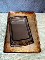 Stacked baking sheets showing range of sizes