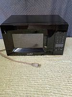 Front view of Comfee black microwave