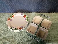 All items: four floral plates beside relish dish rack with bowls