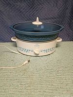 Full view of blue and white Rival Crock-Pot with lid and power cord