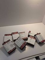 Eight stacks of 1980s Topps baseball cards bundled with paper notes