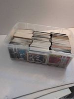 Side view of plastic tub showing stacks of baseball cards