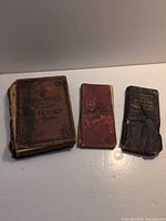 Front view of three pocket dictionaries: Donohue's, Little Webster, Musson's
