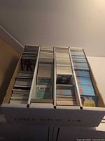 Top view of four-row box filled with hockey cards sorted by dividers