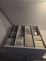 Overall view of four-row cardboard box filled with hockey cards