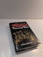 Front view of hardcover with dust jacket showing title and cover art