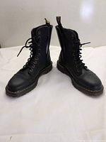 Full view of both boots upright showing lace front, side zippers, yellow stitching