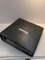 Closed black binder with faint gold deer graphic