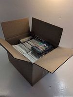 open cardboard box filled with stacked trading cards