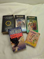 Group shot of all five paperbacks front covers visible