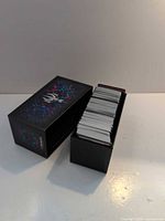 Closed deck box beside stack of cards inside