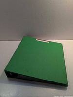 Closed green 3-ring binder