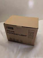 sealed box labeled 8 Pack Solar Pathway Light