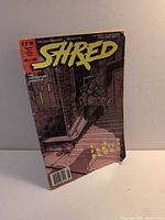 Front cover of Shred Issue #3 comic showing title, artwork and wear on edges