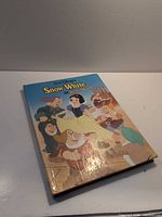 Front cover with title, characters, wear on edges