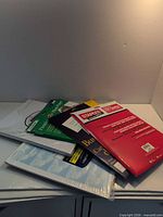 Stack of unopened paper packs on table