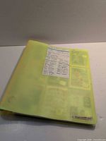 Closed yellow binder with index sheet visible