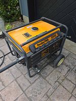 Angled view of Poulan PRO 6600 generator showing fuel tank, frame, wheels, and handles
