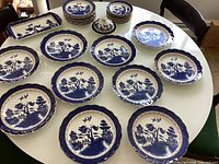 All plates, tray, and covered bowl arranged on table