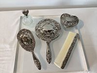 Five vanity pieces arranged on tray