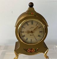 Front view of gold-tone floral table clock