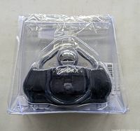 Trimax coupler lock in clear clamshell packaging, top view