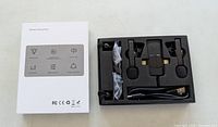 Closed box and open foam tray showing components