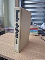 Book standing showing spine with bold lower-case typography and library label