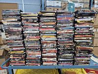 Front view of six tall stacks of DVD cases on a cart