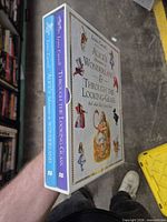 Hand holding slipcase showing both book spines