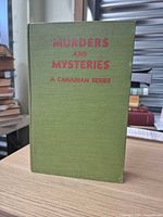 Front cover of green cloth hardcover titled Murders and Mysteries