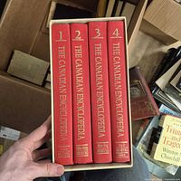 Front view of four red cloth volumes in slipcase