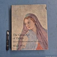 Front of dust-jacketed book next to size reference pen