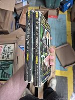 Spine view of both volumes showing titles, publisher and jacket wear